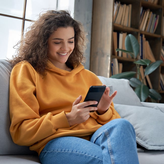 young-woman-using-mortgage-calculator-on-smart-phone